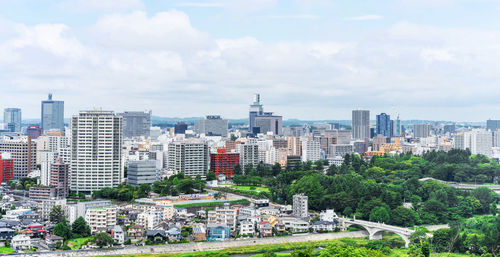 High angle view of buildings in city against sky