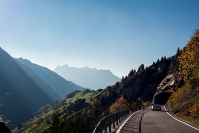 Road amidst trees against sky