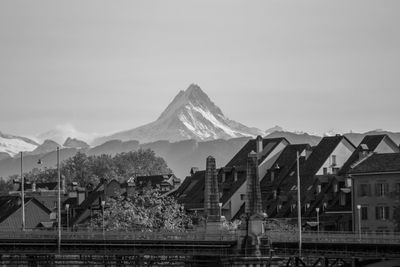 Scenic view of mountains behind buildings of city