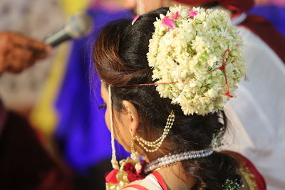 Rear view of bride wearing flowers during wedding