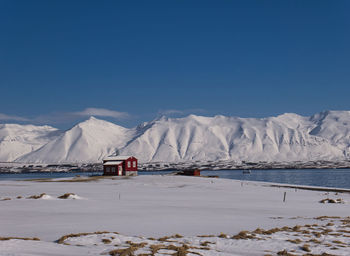 Scenic view of snowcapped mountains against blue sky