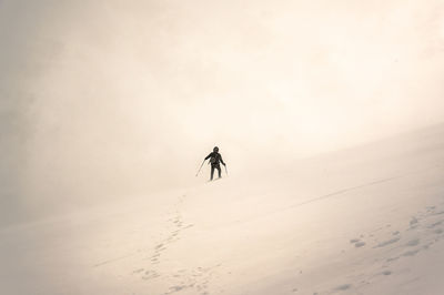 A person walking in snowy mountains