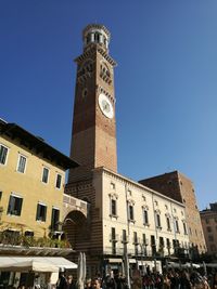 Low angle view of clock tower against blue sky