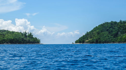 Scenic view of sea against blue sky