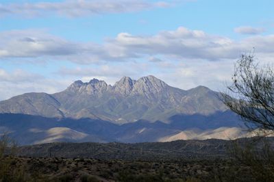 Scenic view of mountains against cloudy sky