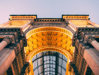 Low angle view of illuminated triumphal arch against clear sky