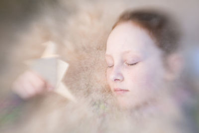 Close-up of girl and origami bird