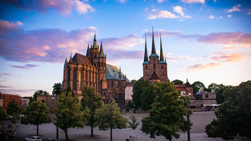 Panoramic view of buildings and trees against sky in city