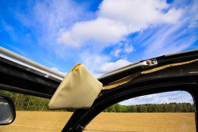 Panoramic view of road amidst field against sky