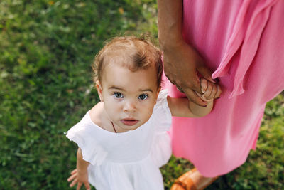 Portrait of mother and daughter on field