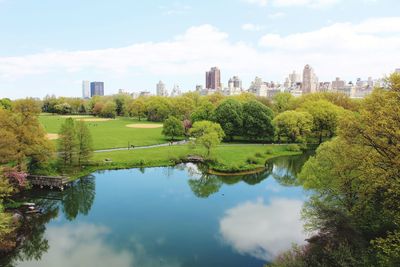 Scenic view of lake by trees against sky