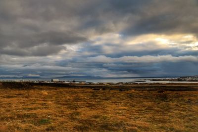 Scenic view of landscape against cloudy sky