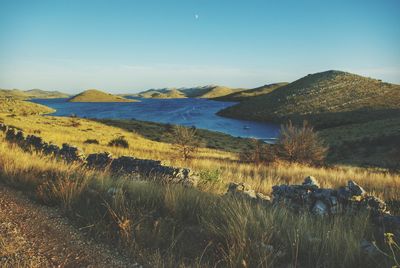 Scenic view of calm lake against cloudy sky