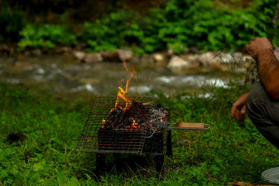 High angle view of man preparing food on barbecue grill