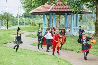 Children wearing costume while running in park