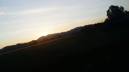 Scenic view of silhouette mountain against sky at sunset