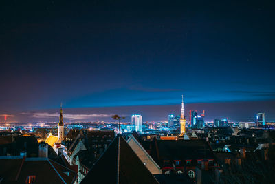 High angle view of buildings lit up at night