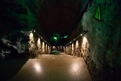 Illuminated tunnel amidst buildings