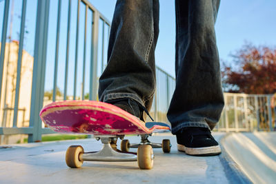 Low section of woman standing on railing