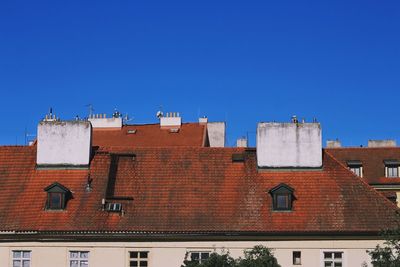 Low angle view of buildings against clear blue sky