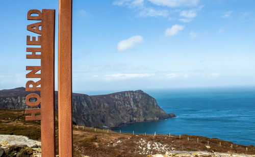 Scenic view of sea and mountains against sky