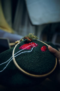Close-up of hand holding red ball