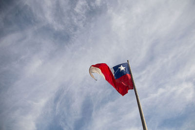 Low angle view of chilean flag waving against sky