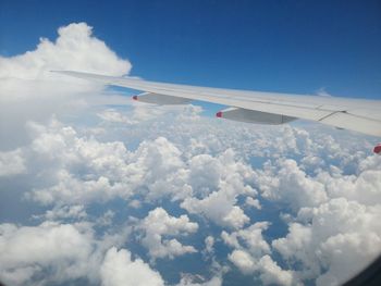 Airplane flying over vapor trail in sky