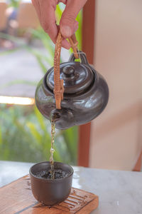 Hand pour chinese or japanese traditional tea from clay pot