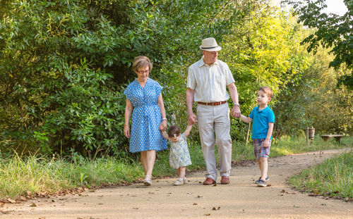 Grandparents walking with grandchildren at park