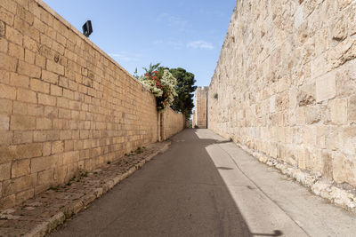 Empty road along walls