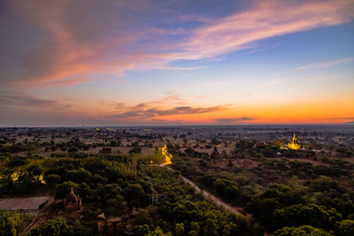 Aerial view of buildings against sky during sunset