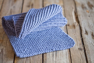 High angle view of blue woolen textile on wooden table