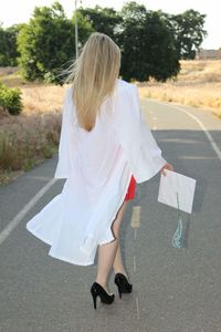 Rear view of woman walking on road in city