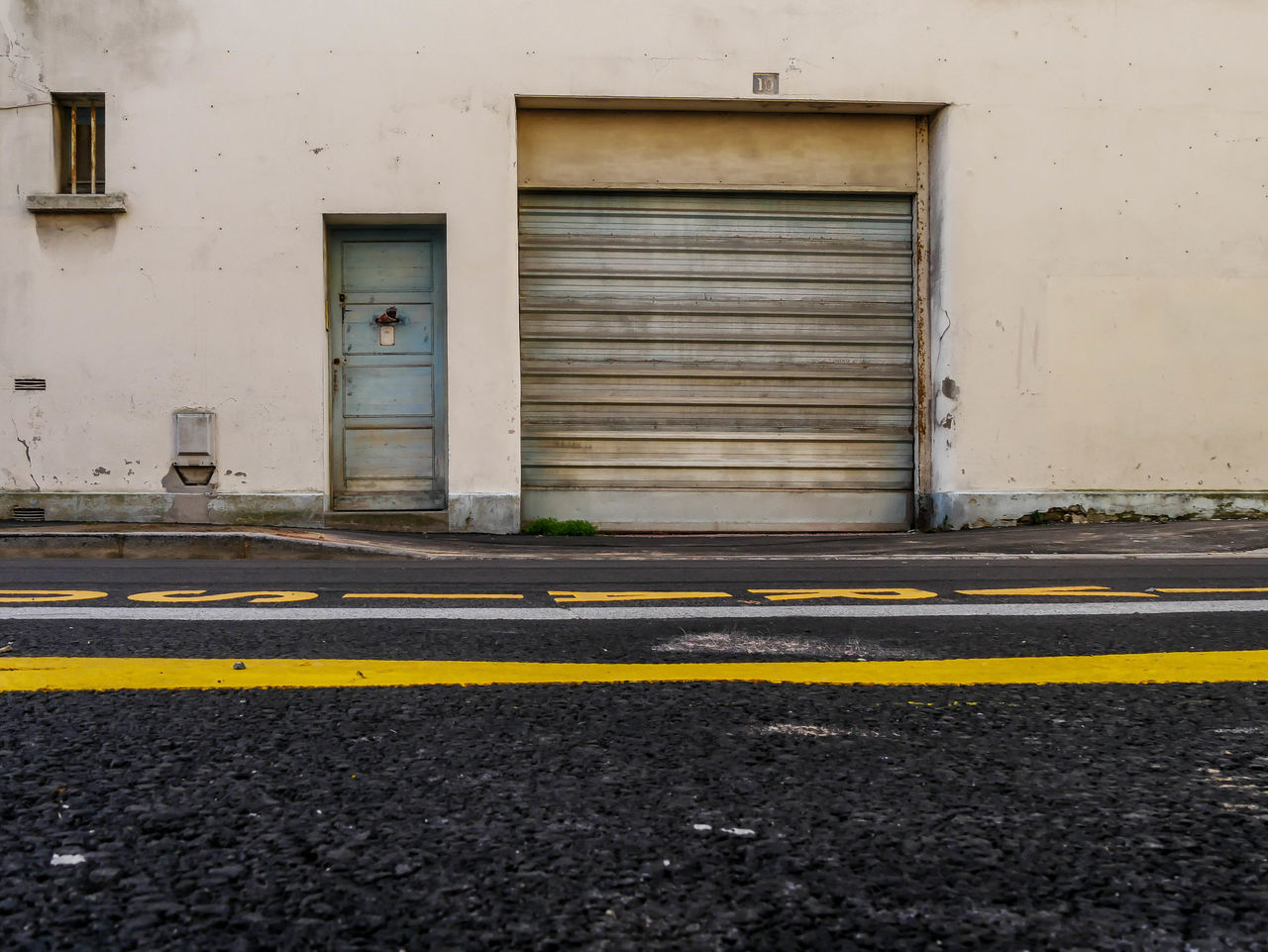architecture, built structure, building exterior, city, transportation, building, entrance, door, no people, sign, road, street, day, yellow, closed, road marking, outdoors, marking, empty, asphalt, dividing line