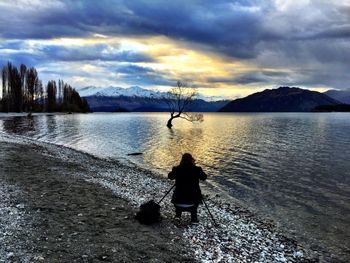 Scenic view of lake against cloudy sky