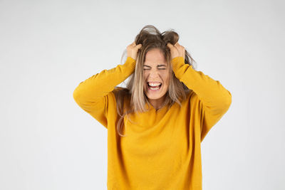 Portrait of a smiling young woman over white background