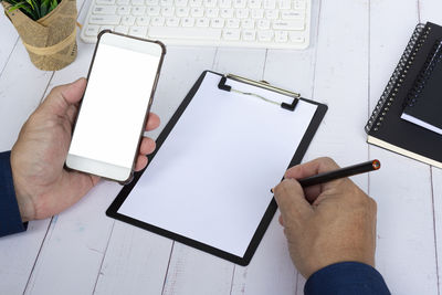 Low section of woman using digital tablet