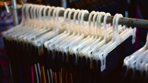 Close-up of clothes hanging in row