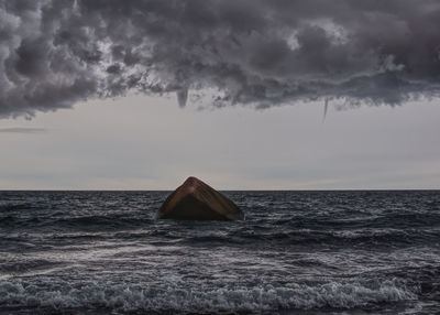 Sailboat on sea against sky