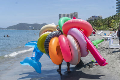 Multi colored umbrellas on beach against sky