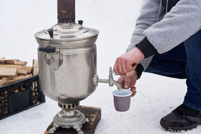 Midsection of man with coffee beans in winter