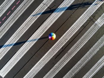 Directly above shot of person with multi colored umbrella on road