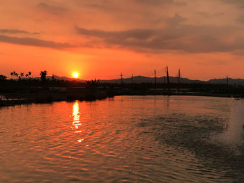 Scenic view of sea against orange sky