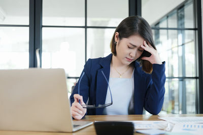 Mid adult woman using mobile phone