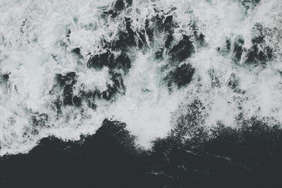 High angle view of sea waves splashing on shore