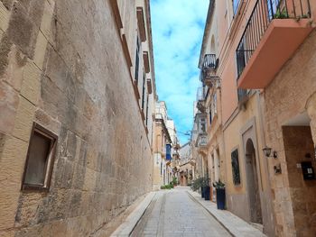 Narrow alley amidst buildings in town