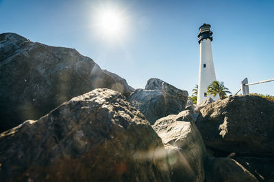 Low angle view of rocks against sky on sunny day