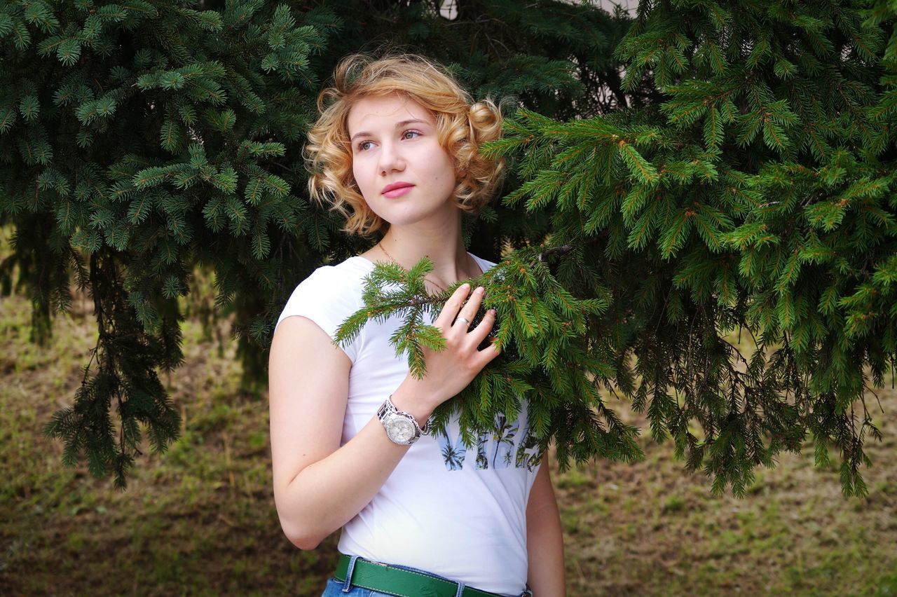 young adult, one person, real people, young women, plant, green color, beautiful woman, tree, nature, lifestyles, outdoors, day, blond hair, growth, standing, beauty, beauty in nature, people