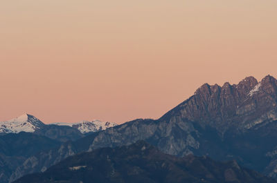 Scenic view of snowcapped mountains against sky during sunset